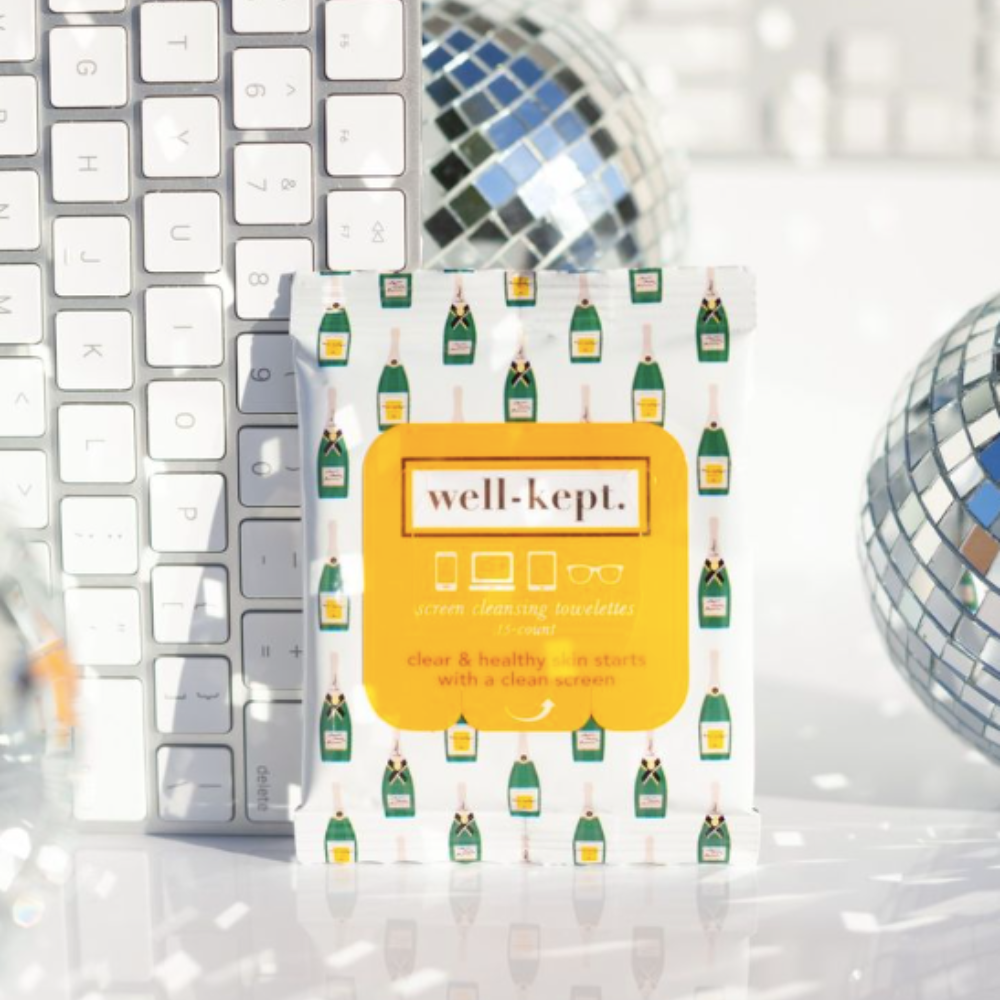 BUBBLY - TWELVE PACK (12) pre-moistened electronic cleaning towelettes with a champagne bottle design are shown next to a keyboard and disco balls.