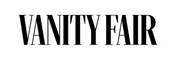 Black "VANITY FAIR" text logo in bold, uppercase letters on a light gray background.