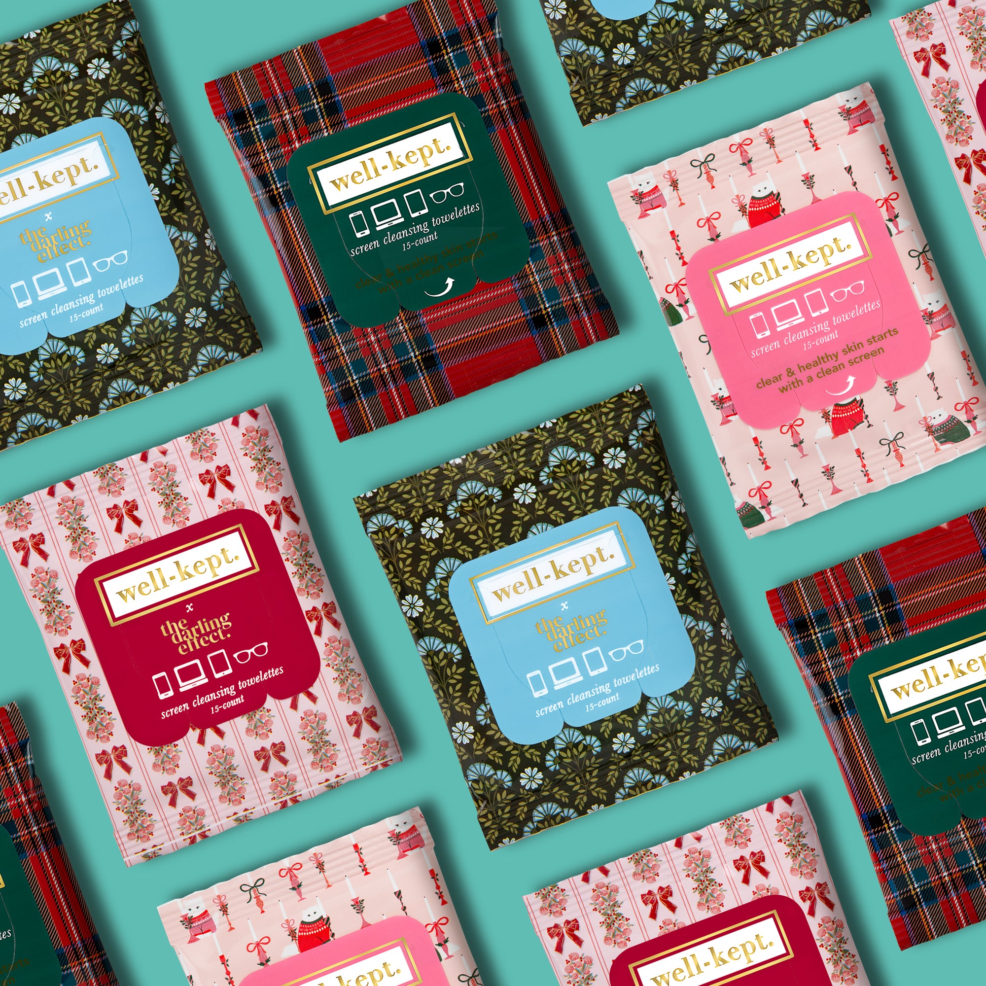 Flat lay of "TWICKENHAM - Twelve Pack (12)" patterned, pre-moistened towelettes in festive holiday packaging on turquoise—perfect electronics cleaning wipes from a leading woman-owned brand.