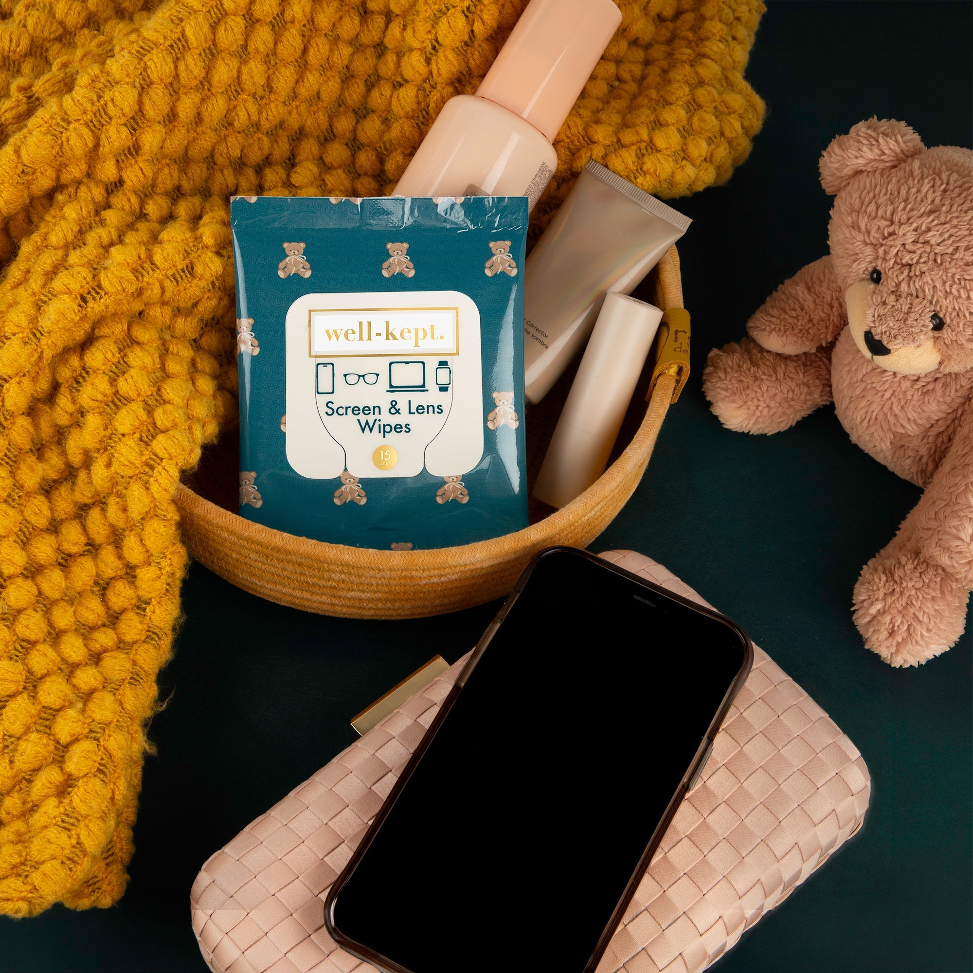 up close image of woman's hand wiping phone with Well-Kept screen wipes.