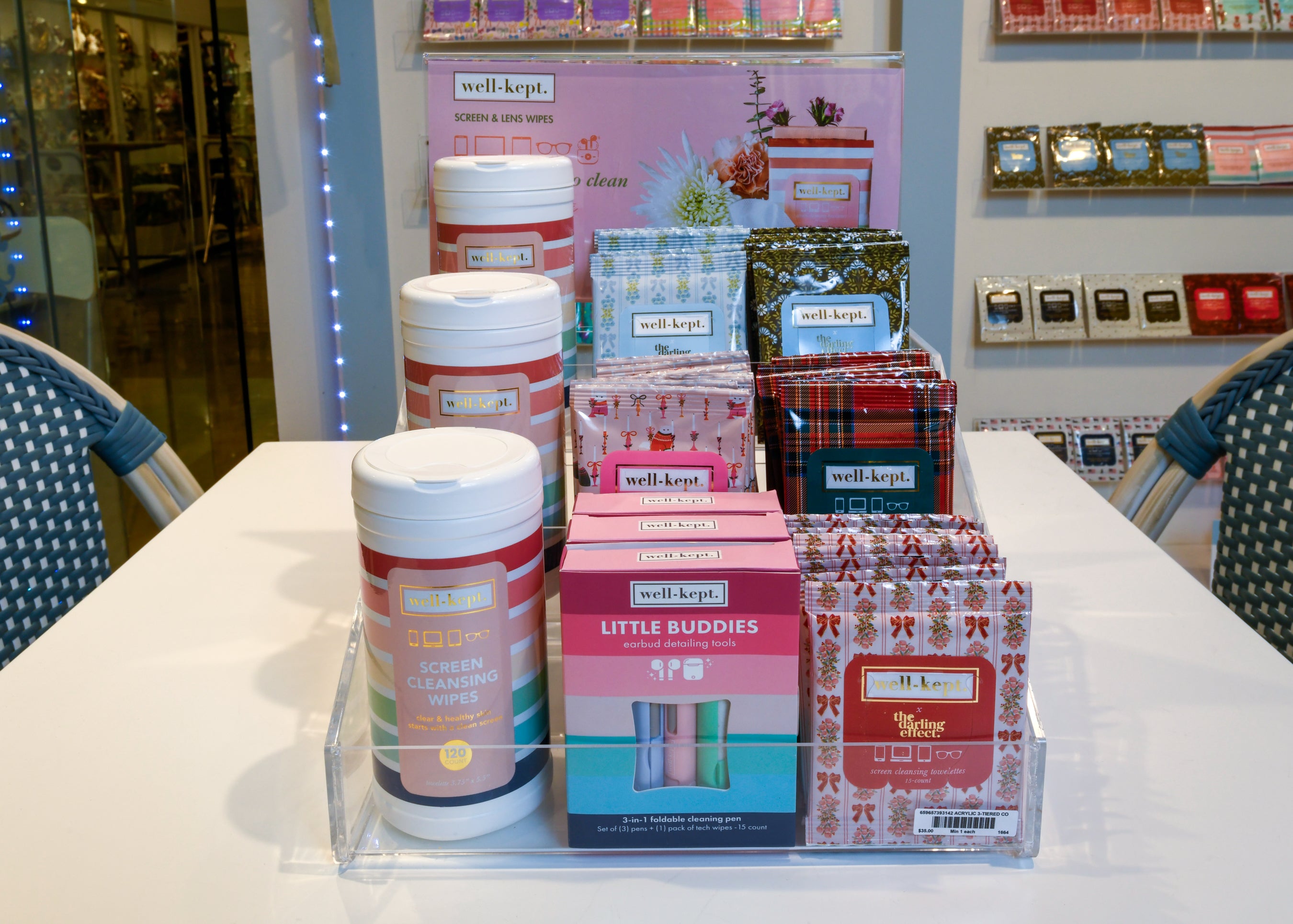 The ACRYLIC 3-TIERED COUNTER DISPLAY presents screen cleaning wipes and cloths, organized on a white table for an attractive in-store merchandising solution.