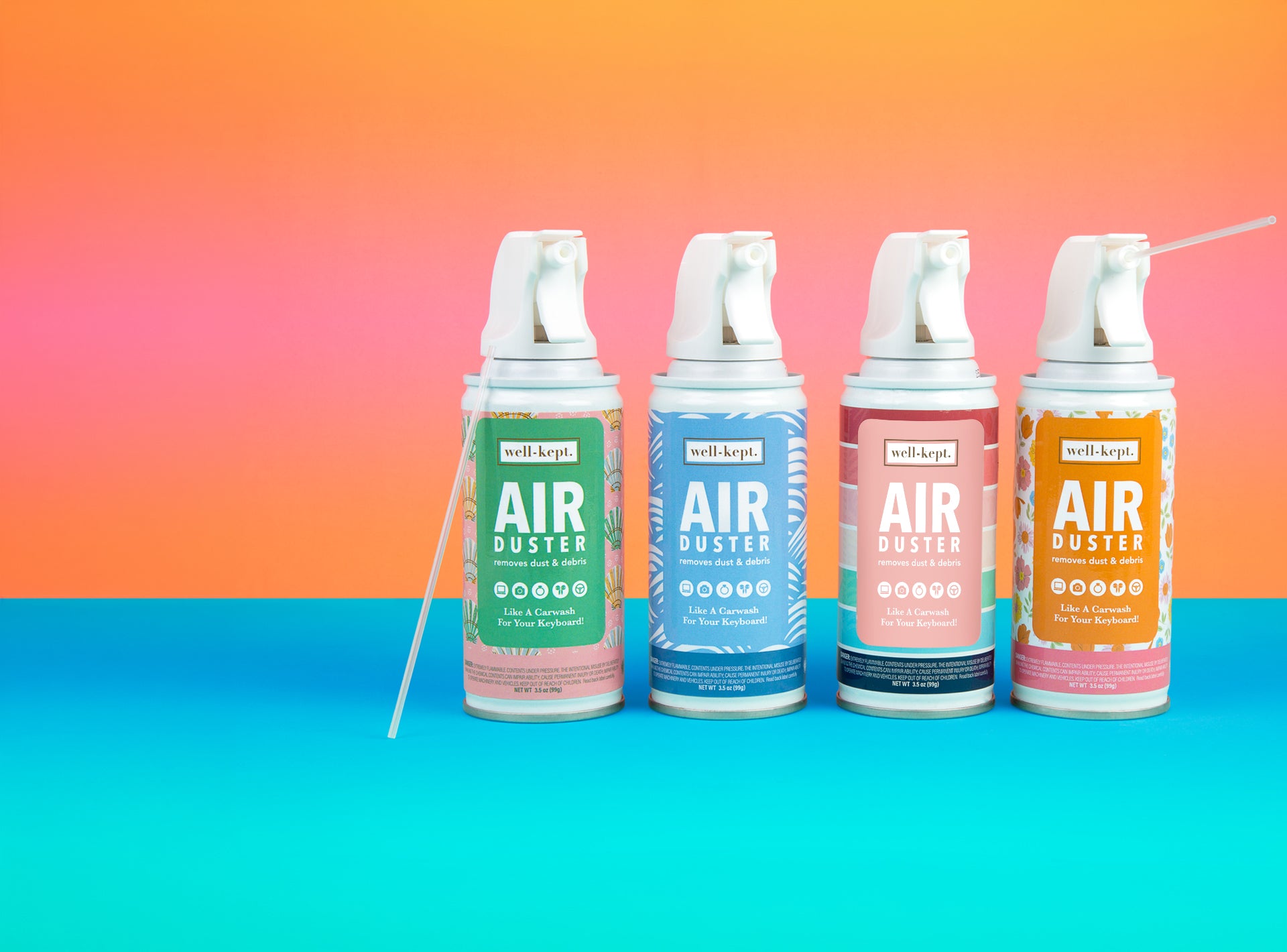 Four Well-Kept Air Duster cans in green, blue, red, and orange, standing against an orange and teal background