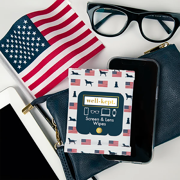 Old Glory flag and dog print Well-Kept screen and lens wipes pack styled with a small American flag, glasses, and a phone