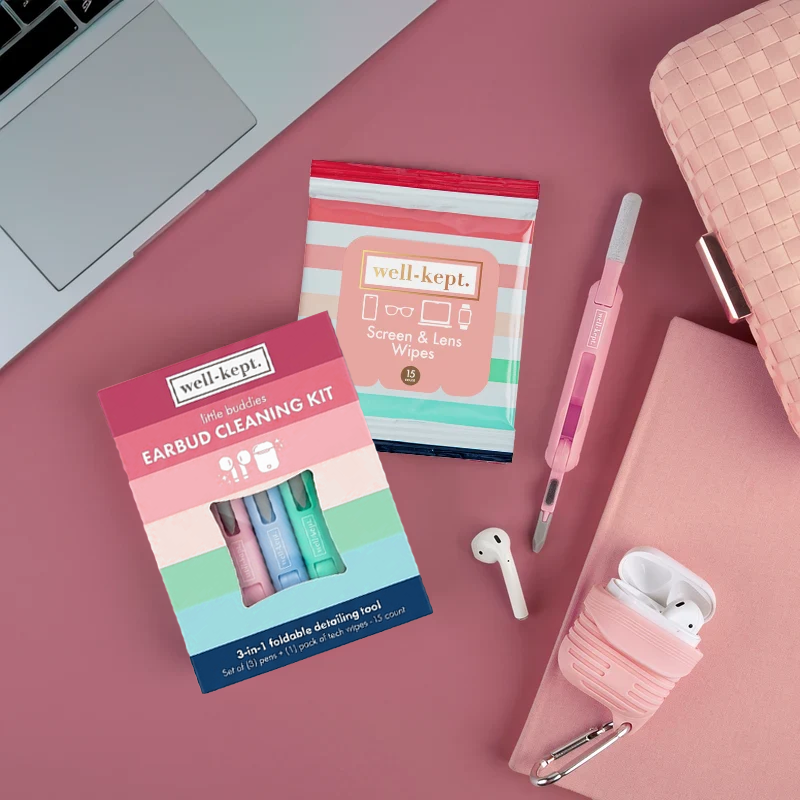 Better Days Little Buddies earbud cleaning kit and Well-Kept screen and lens wipes pack styled with earbuds and a pink pouch